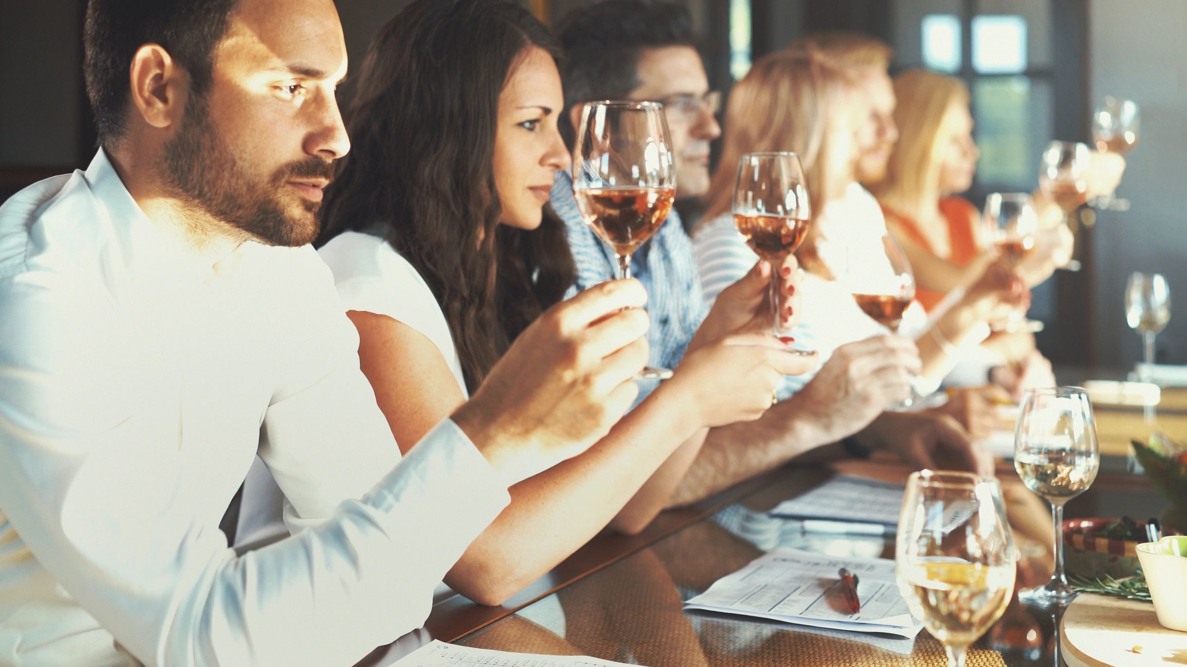 Wellness-focused wine tasting event with participants engaging in mindful sipping